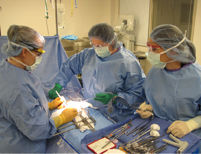 Surgery Technology students hands on learning on the operating table.
