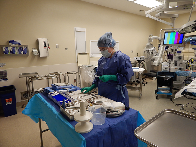 Surgery Tech Student preparing operating table