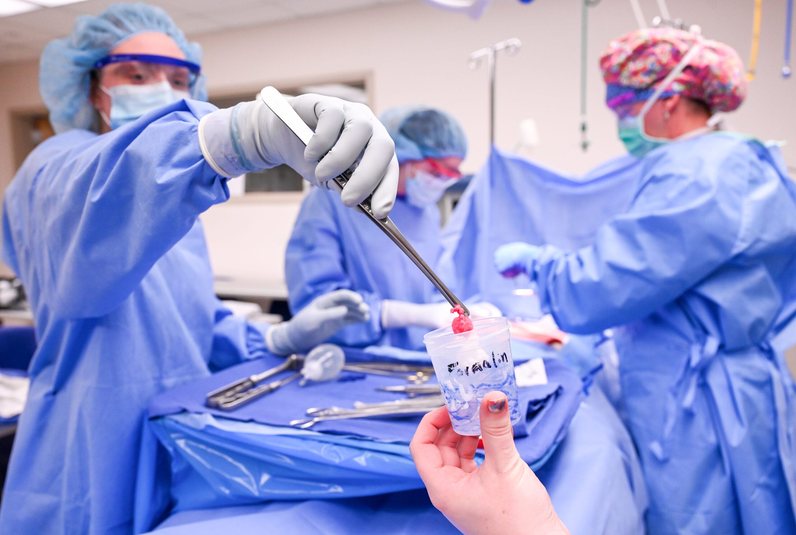 Photo of surgery with surgical technicians working
