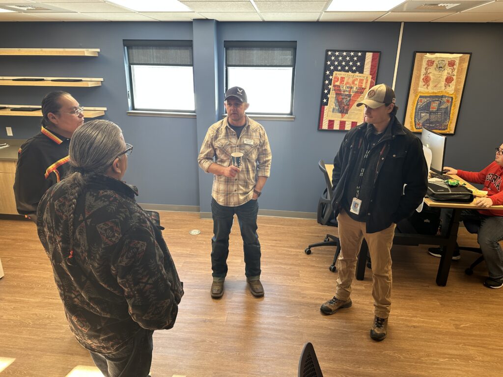 5 people standing and talking in the new Military Family Center at Great Falls College